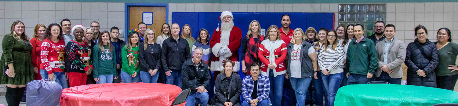 Spirit AeroSystems employees opening gifts with Heartspring students