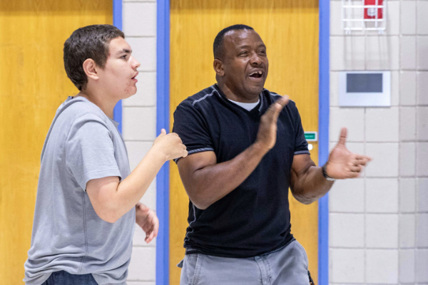 Robert Reynolds playing volleyball with students in Heartspring gym